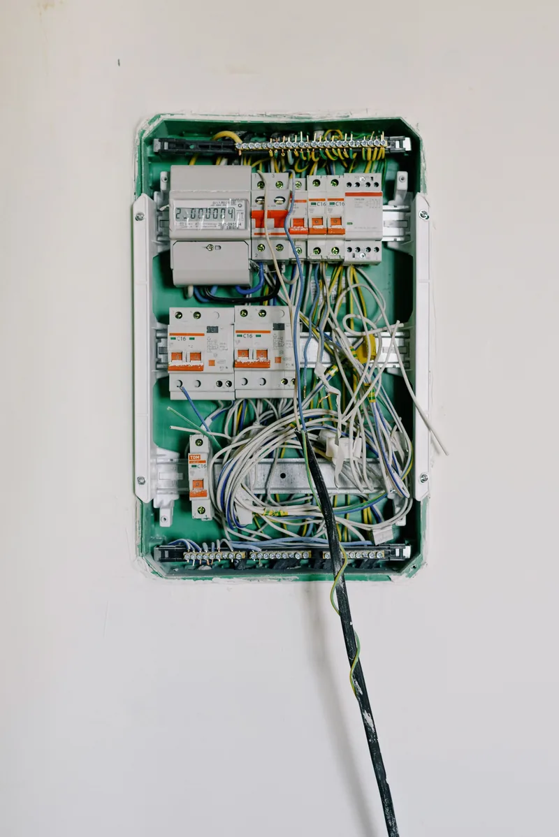 Licensed electrician installing a surge protective device inside a residential electrical panel